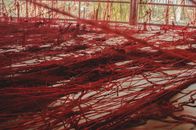 Messy red threads in workshop for sewing fabrics