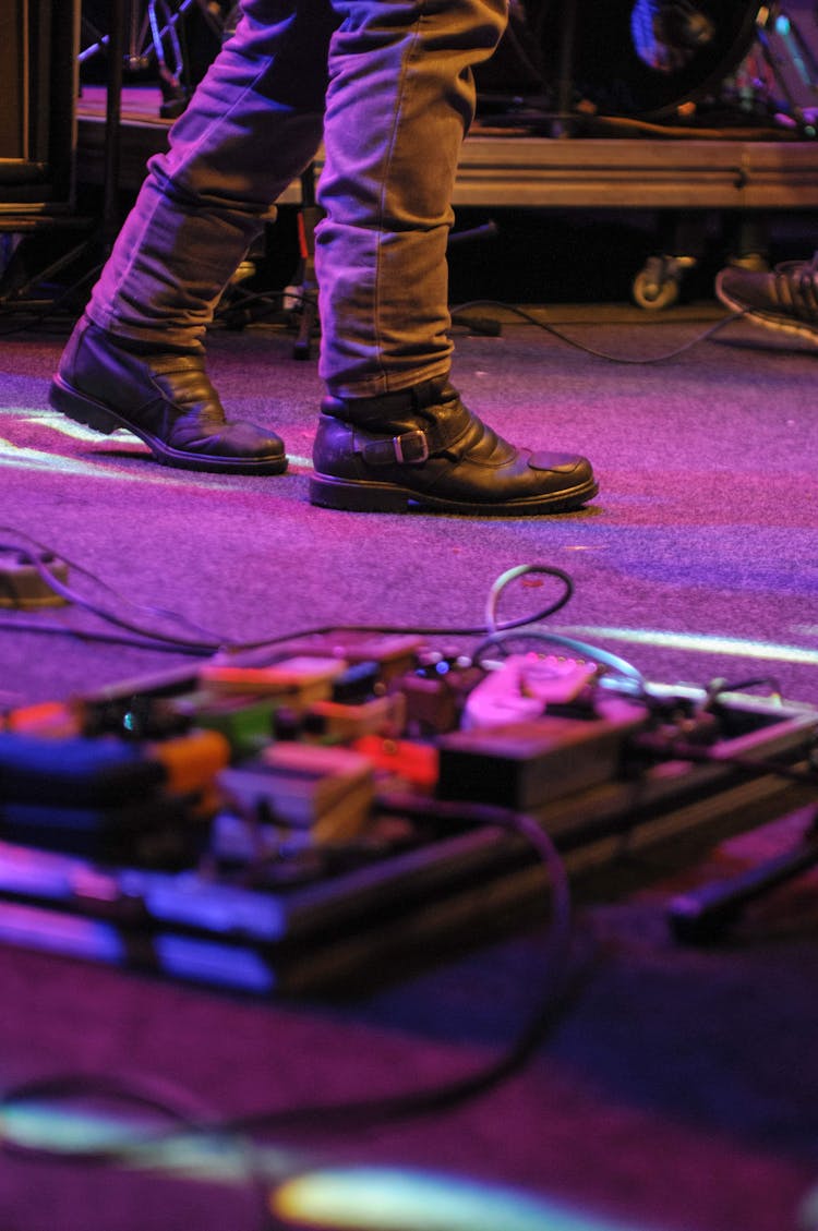 Unrecognizable Man On Stage With Equipment