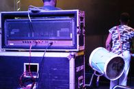 Unrecognizable drummer on stage with sound equipment