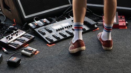 Free Crop man on stage with pedalboard Stock Photo