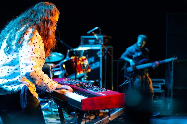 Man Playing Synthesizer On Stage