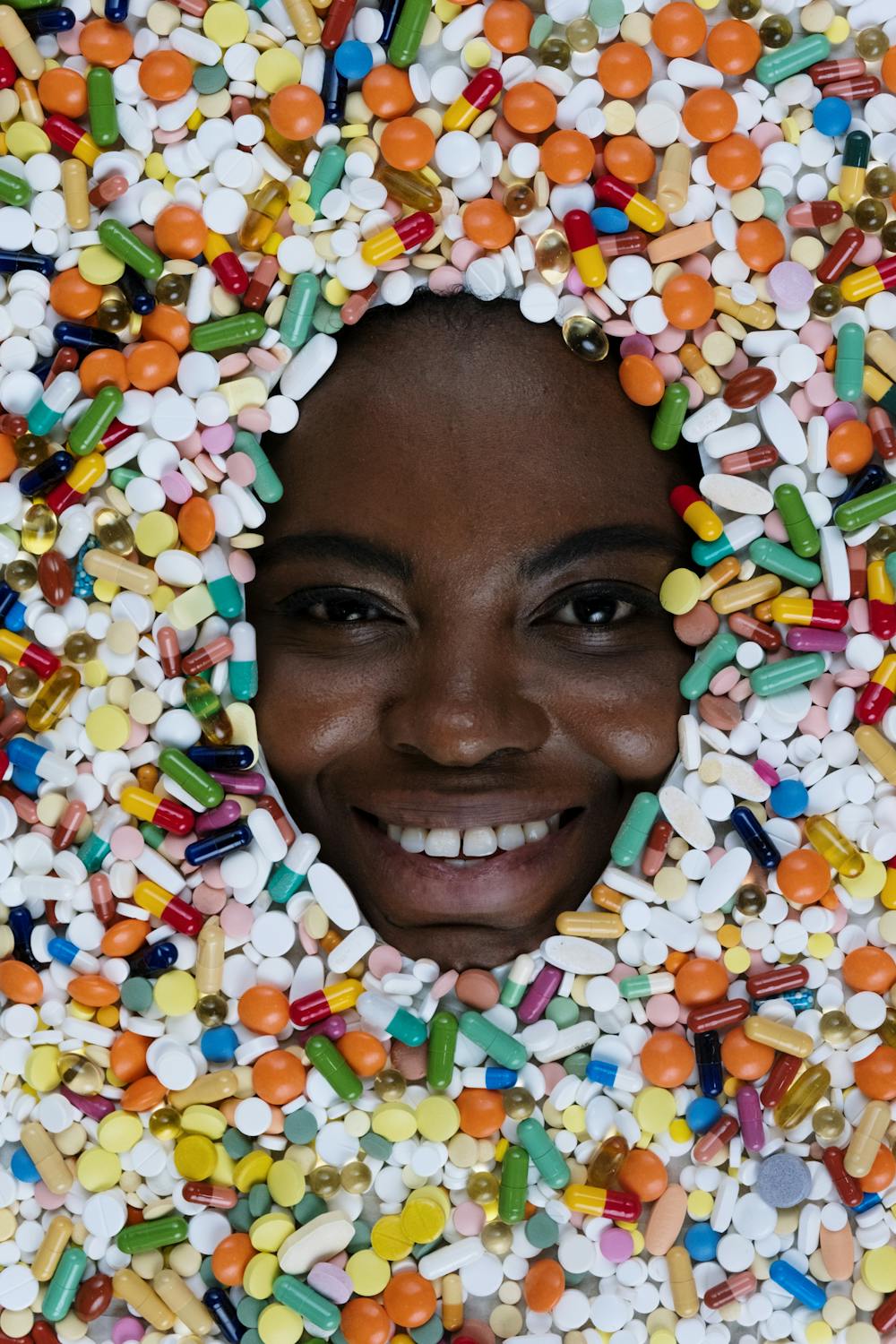 happy face surrounded by pills
