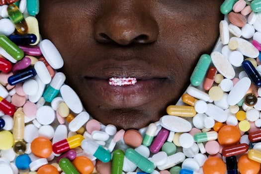 Artistic depiction of a person's lips surrounded by colorful pills reflecting healthcare and medication themes.