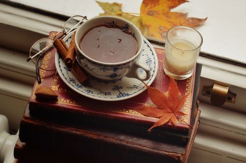 Free Warm autumn scene with tea and cinnamon on a window sill, perfect for cozy moments. Stock Photo