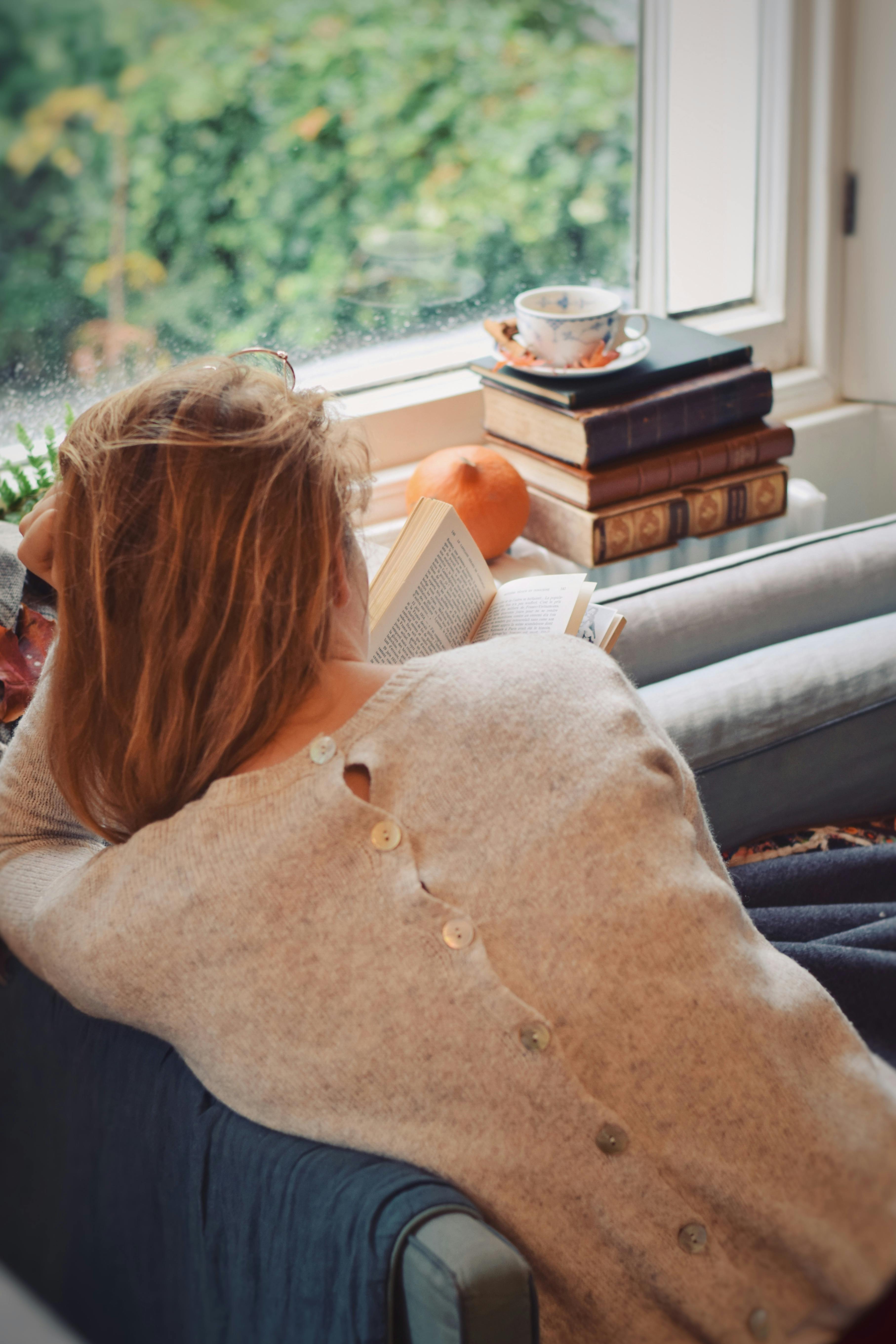 Back View of Woman Sitting Reading a Book · Free Stock Photo