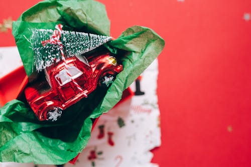 A Toy Car Carrying a Christmas Tree
