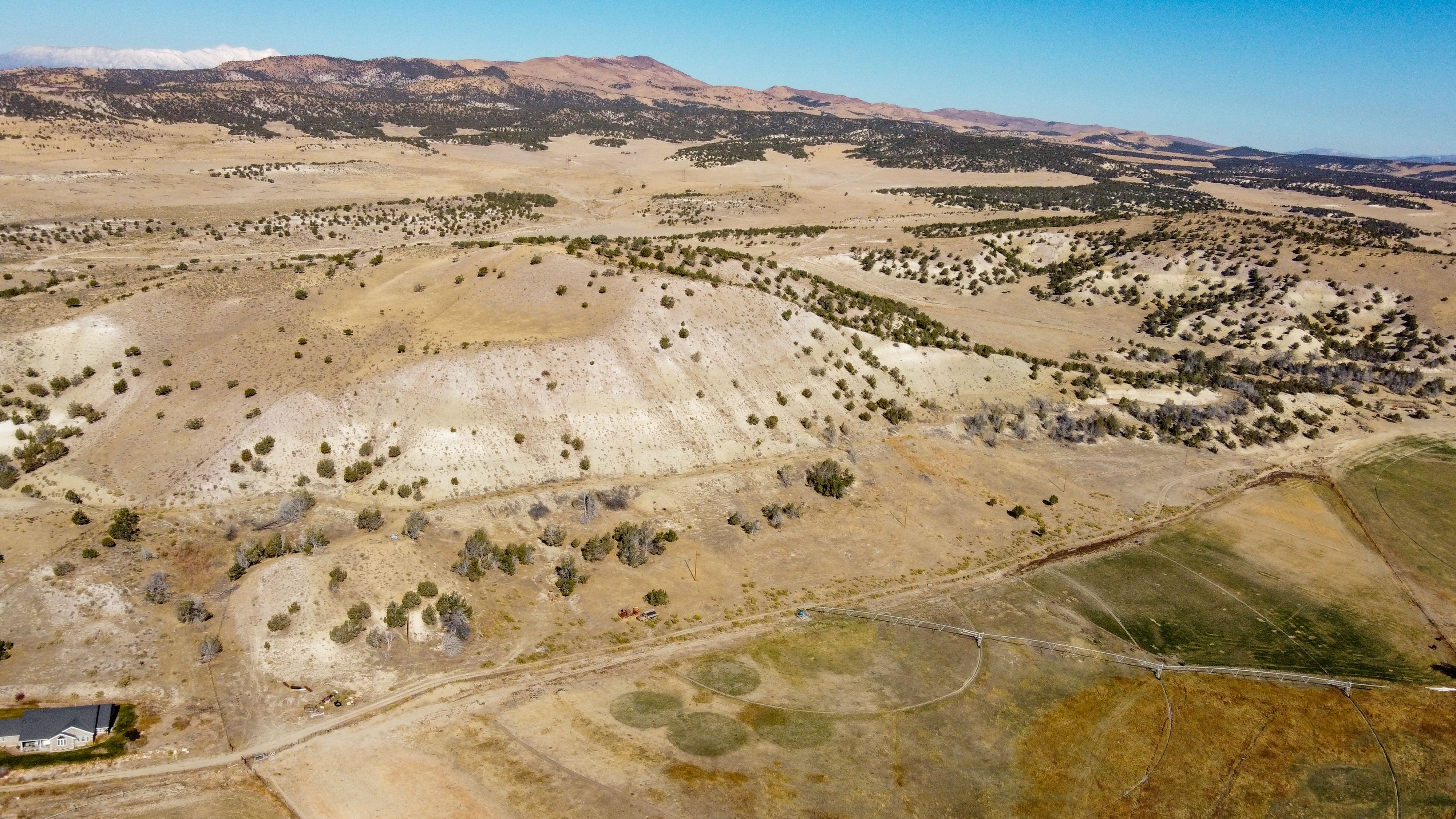 Stunning aerial view of Mount Pleasant, Utah's rural landscape with rolling hills.