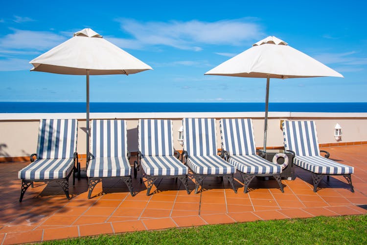 Chaise Lounges Under Patio Umbrellas