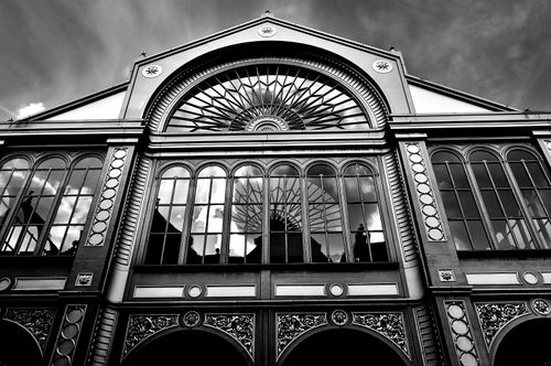 Free Low angle view of a monochrome architectural facade featuring ornate arched windows and intricate designs. Stock Photo