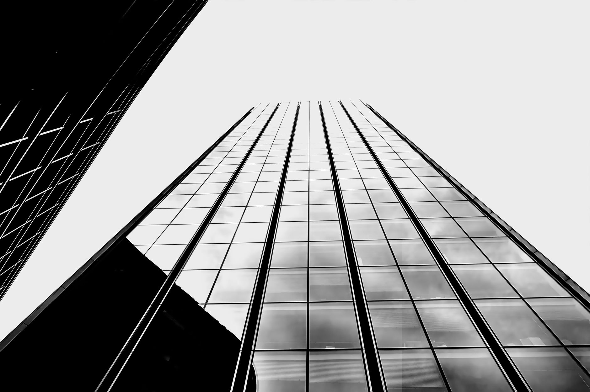 A sophisticated architectural blueprint of a modern glass skyscraper reflecting a sunset skyline, symbolizing strategic market foresight.