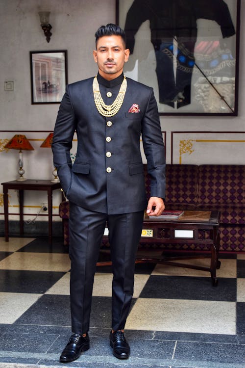 Man in Black Suit Standing in the Living Room