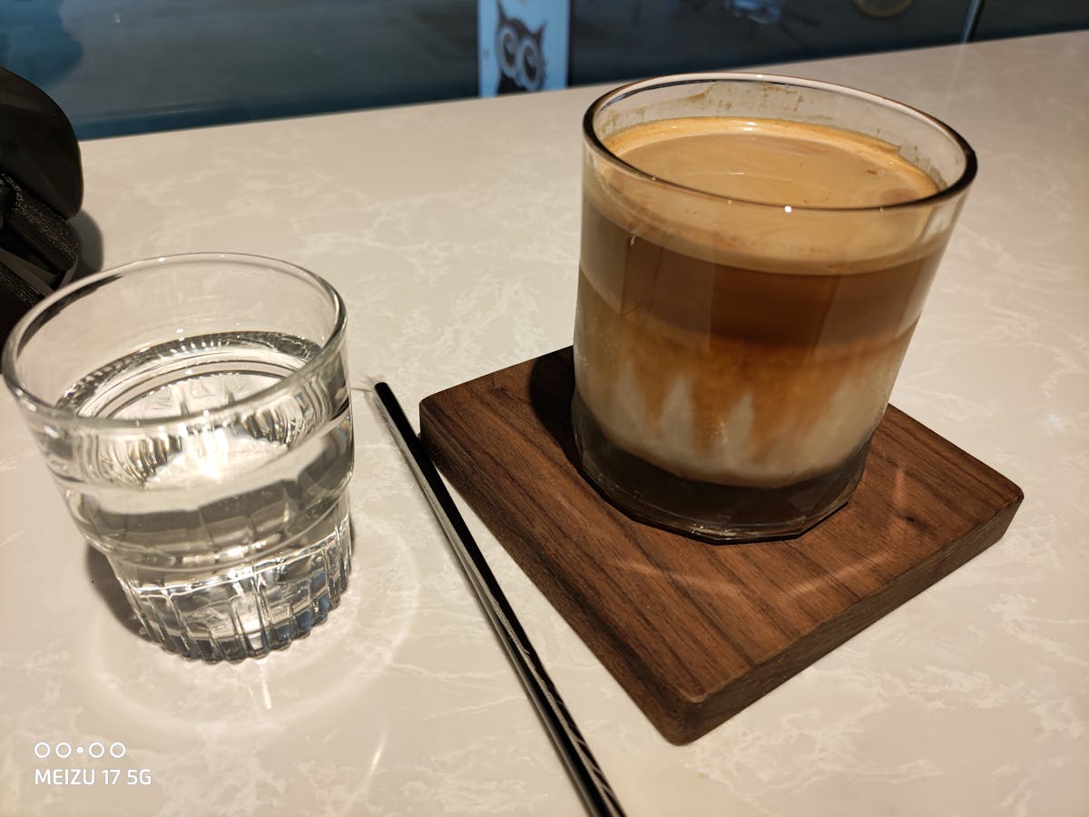 Person editing AI-generated holiday video on a laptop with festive lights in the background