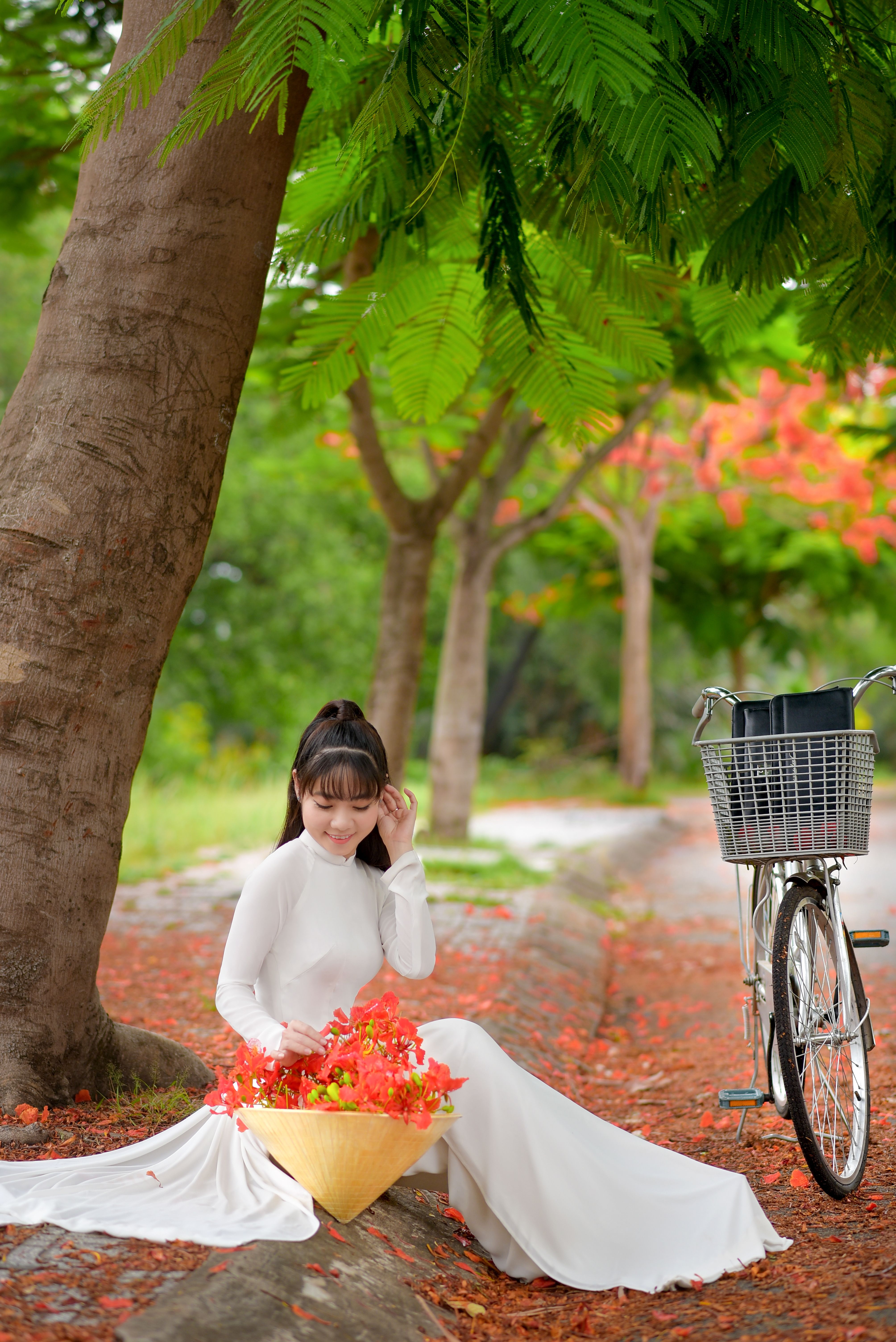 Woman in White Long Sleeve Dress Sitting Near Tree · Free Stock Photo