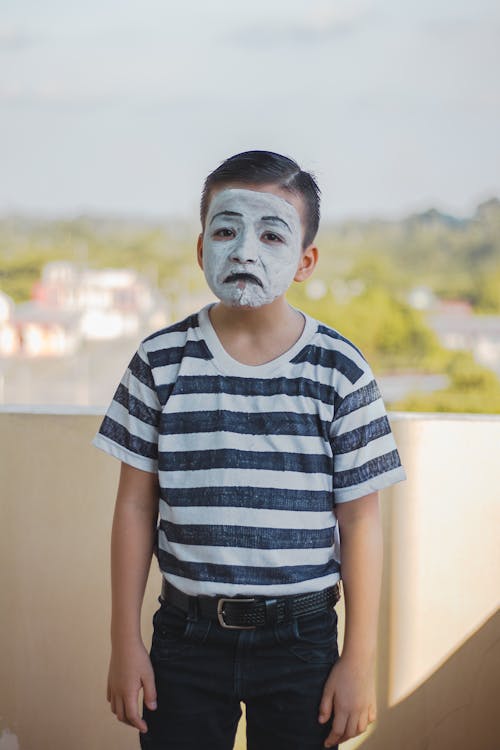 Free Boy in Blue and White Striped Shirt with a Face Paint Stock Photo
