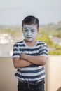A Boy Wearing a Face Paint Mask and Striped Shirt