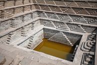 From above or stone rows of stairs of stepped well with dirty water in Hampi India