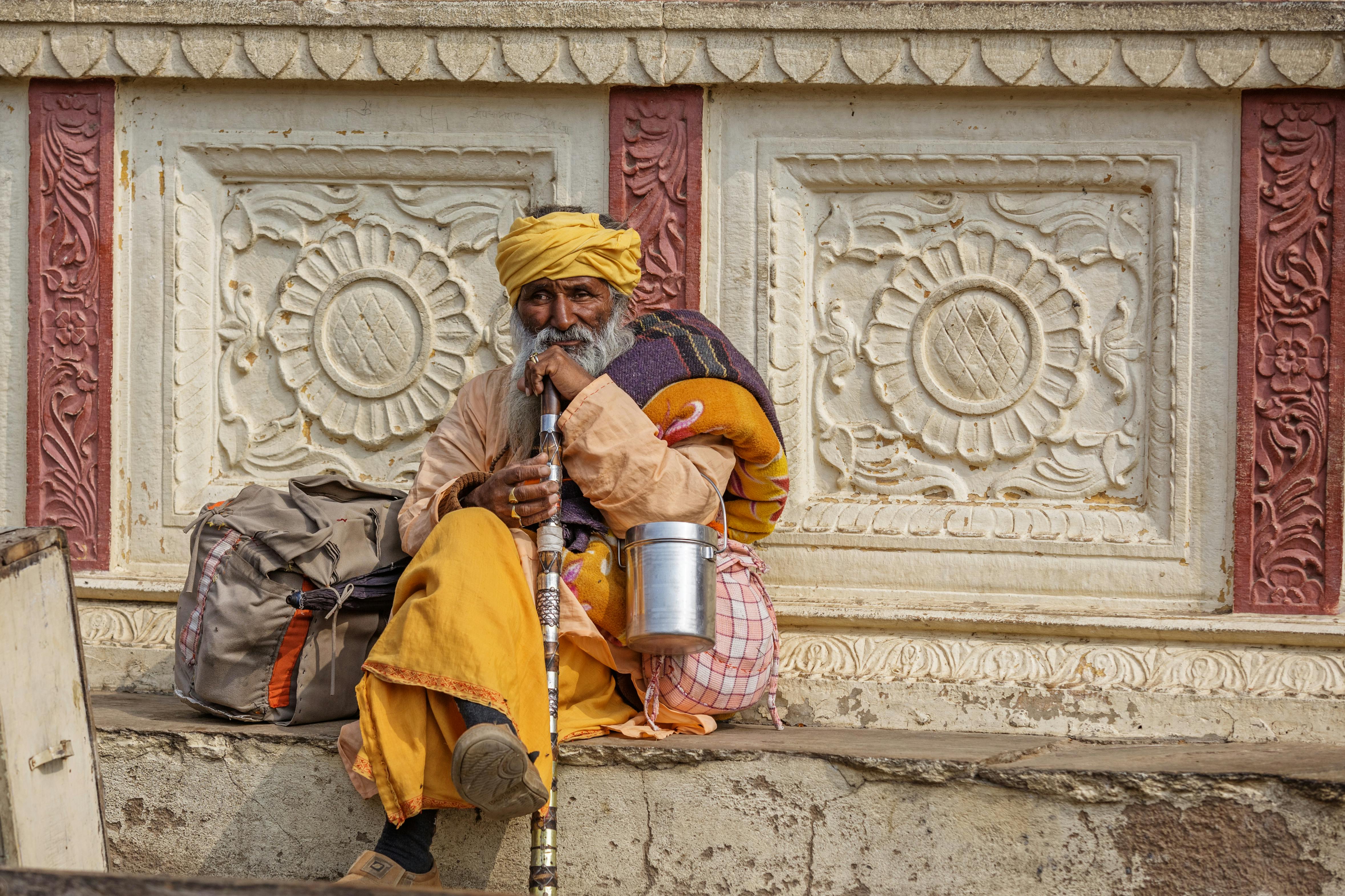 senior hindu man with cane on street