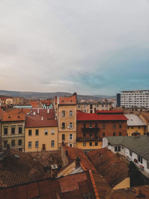 Free Explore the charming architecture and vibrant rooftops of Cluj-Napoca, Romania, showcasing urban beauty. Stock Photo