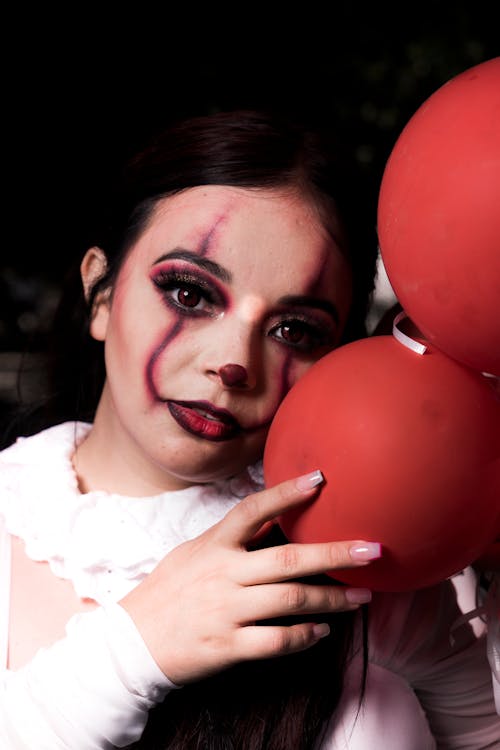 Woman Holding Red Balloons