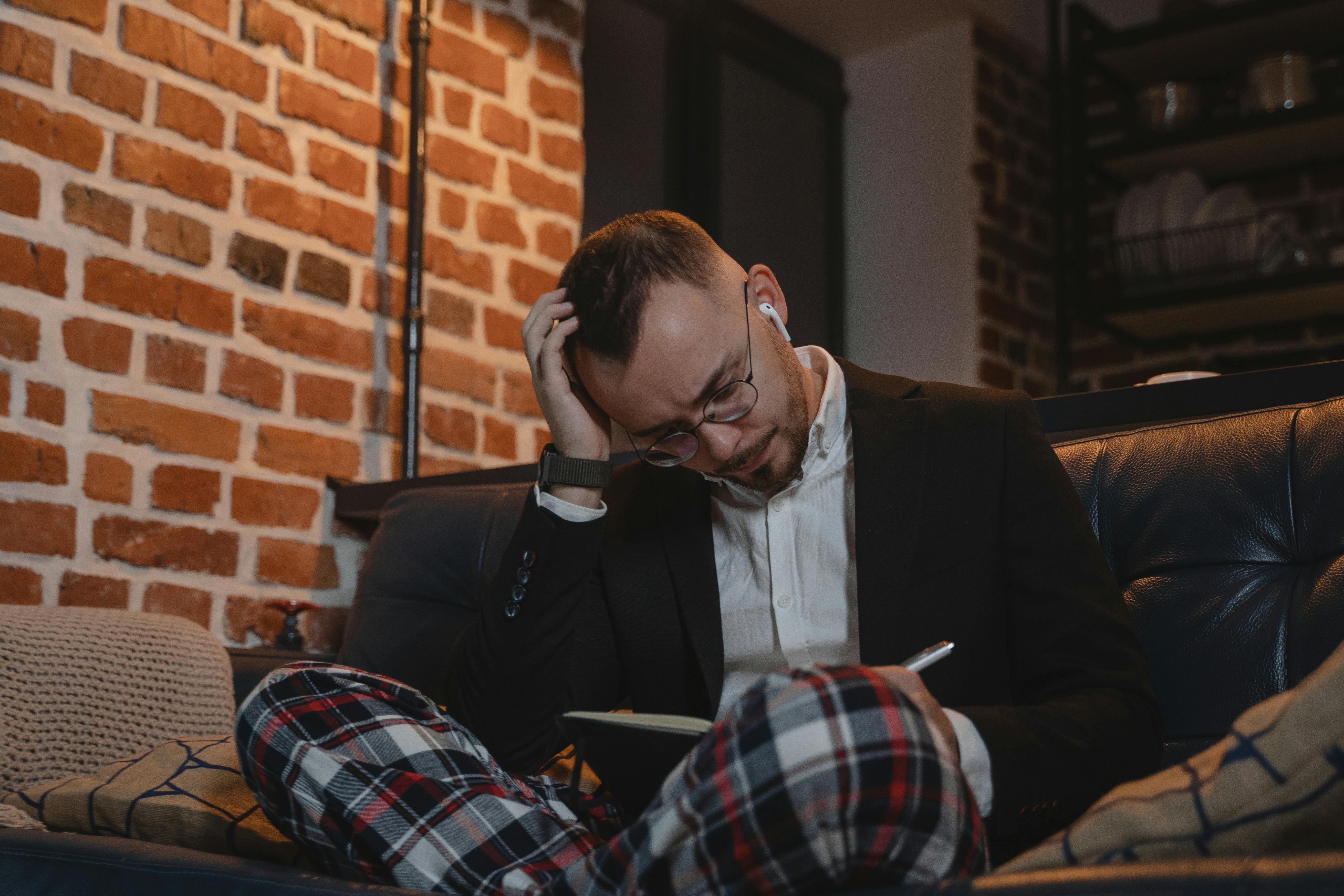 man in black suit jacket sitting on chair