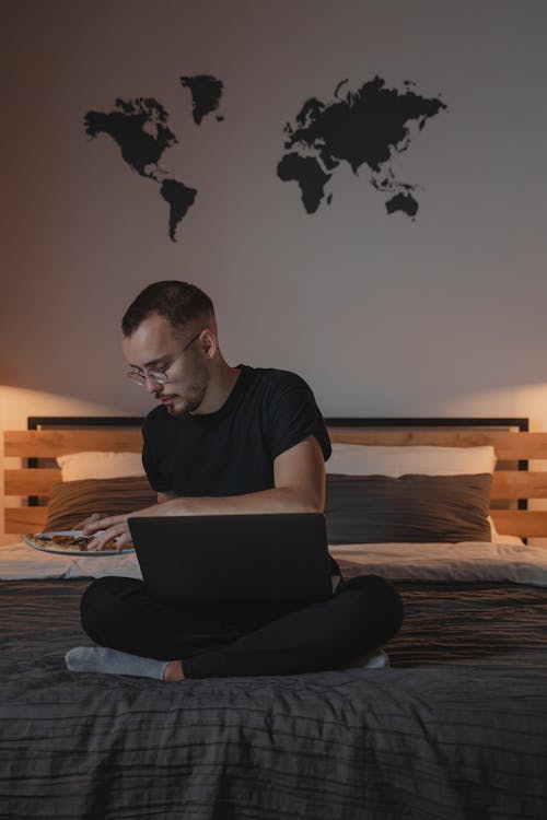 Man in Black Crew Neck T-shirt Using Black Laptop Computer