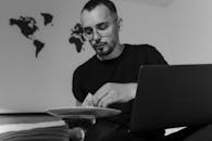 Man in Black Crew Neck Shirt Wearing Eyeglasses Holding White Ceramic Plate