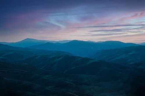 Free Marvellous landscape of dark valley with mountains under cloudy sky with sunset light Stock Photo