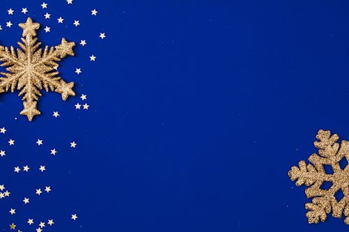 Gold Stars and Gold Snowflakes on Blue Background