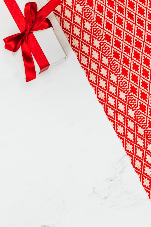 Free Red and White Textile on White Floor Stock Photo
