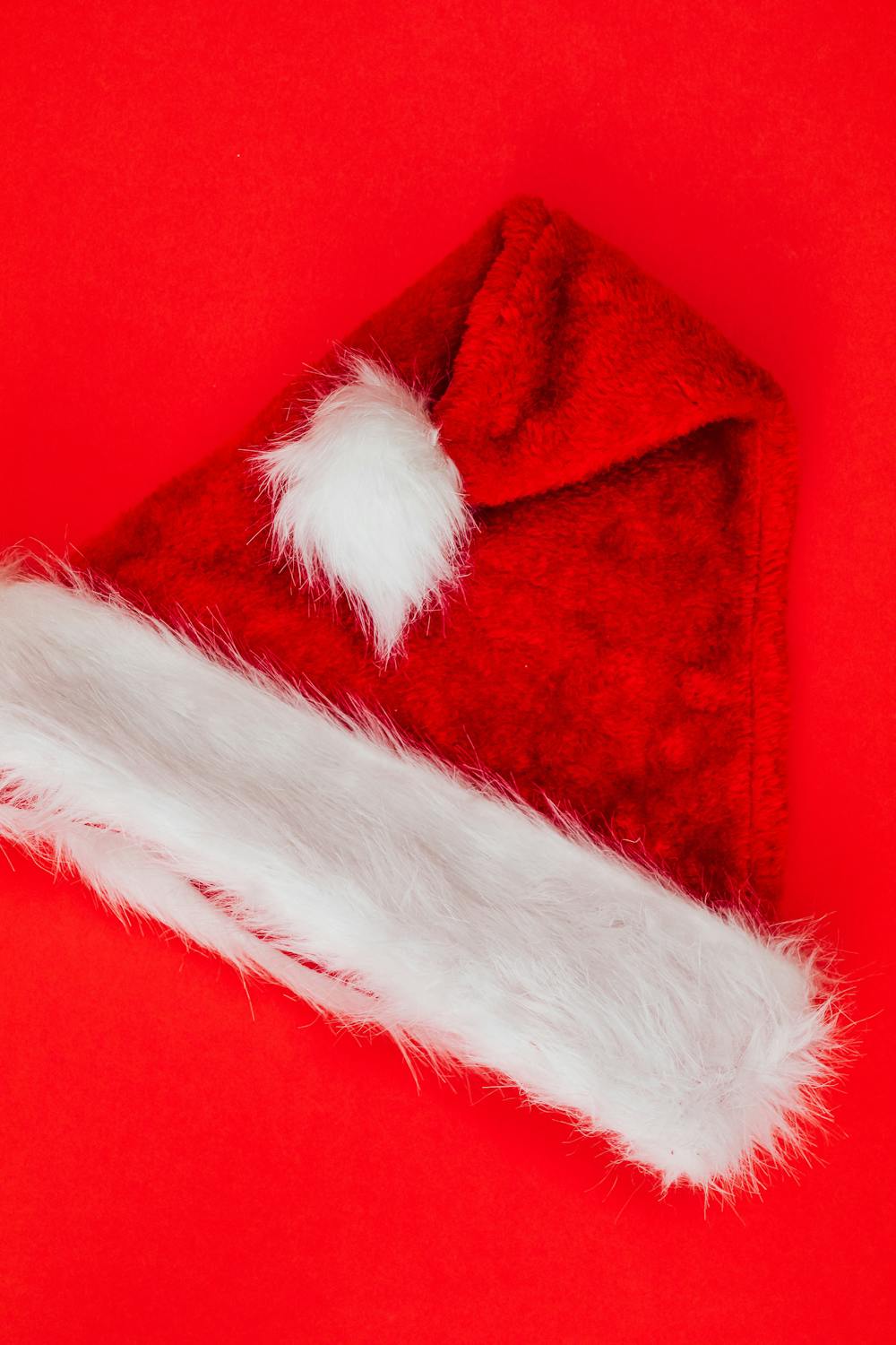 Santa Hat on Red Studio Background · Free Stock Photo