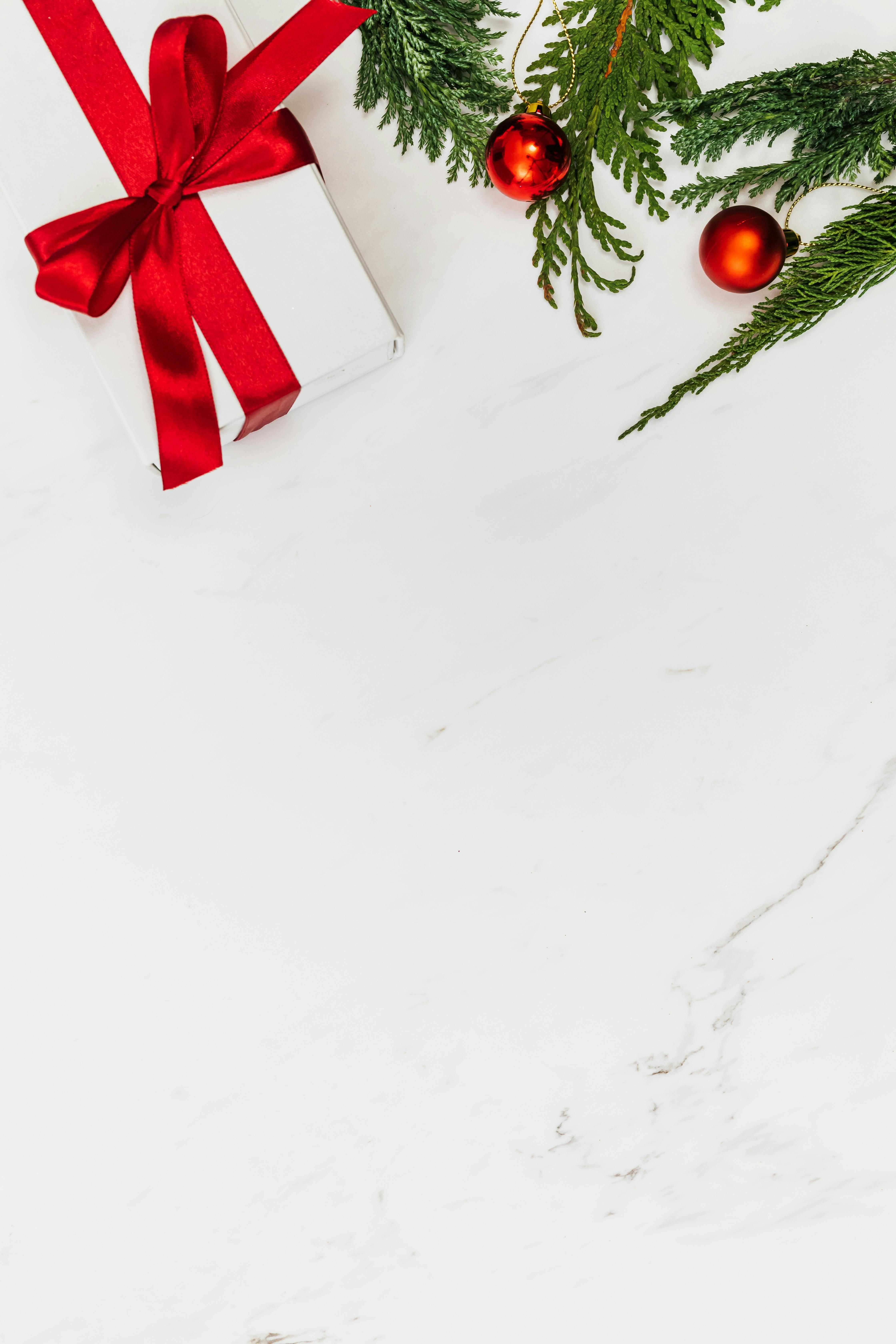 Overhead Shot of a Gift Near Red Christmas Balls · Free Stock Photo