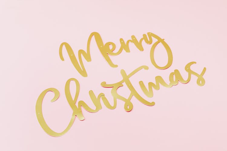 Merry Christmas Text On A Pink Surface