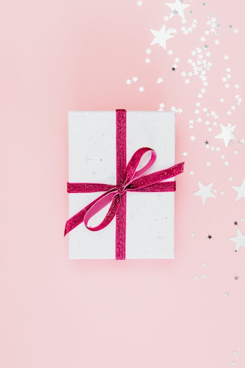 Free Close-Up Shot of a Gift Wrapped with Pink Ribbon Stock Photo
