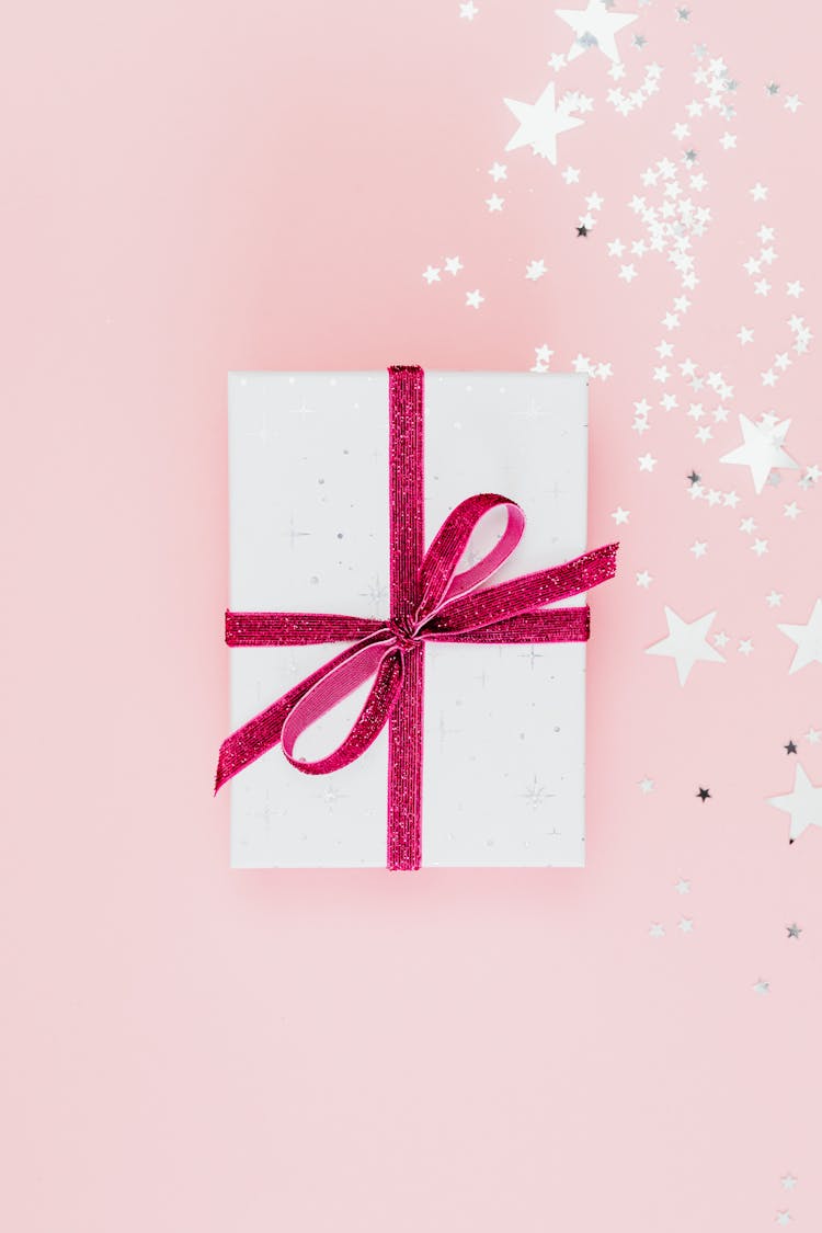 Close-Up Shot Of A Gift Wrapped With Pink Ribbon