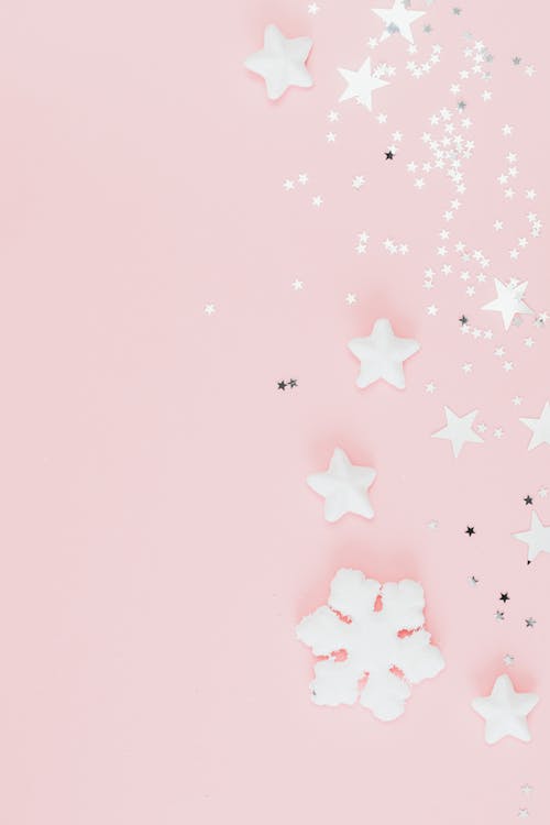 Free Close-Up Shot of White Stars on a Pink Surface Stock Photo
