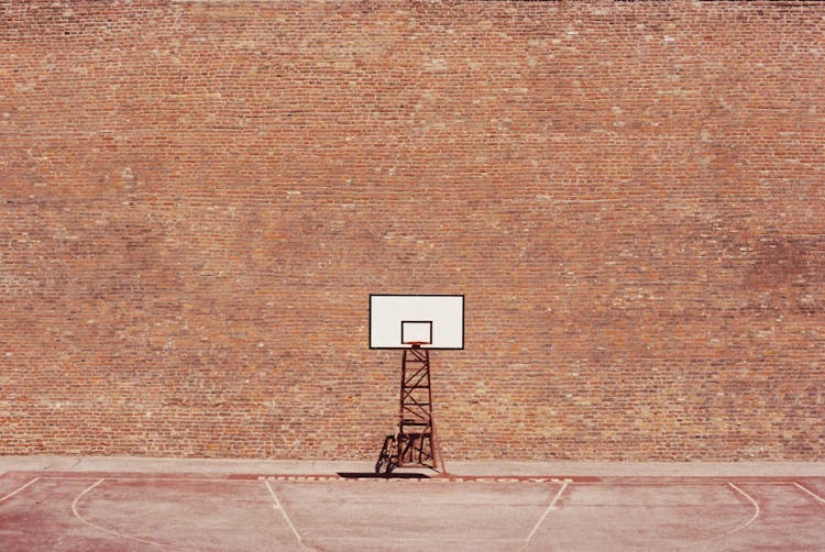 Basketball Hoop Against Brick Wall