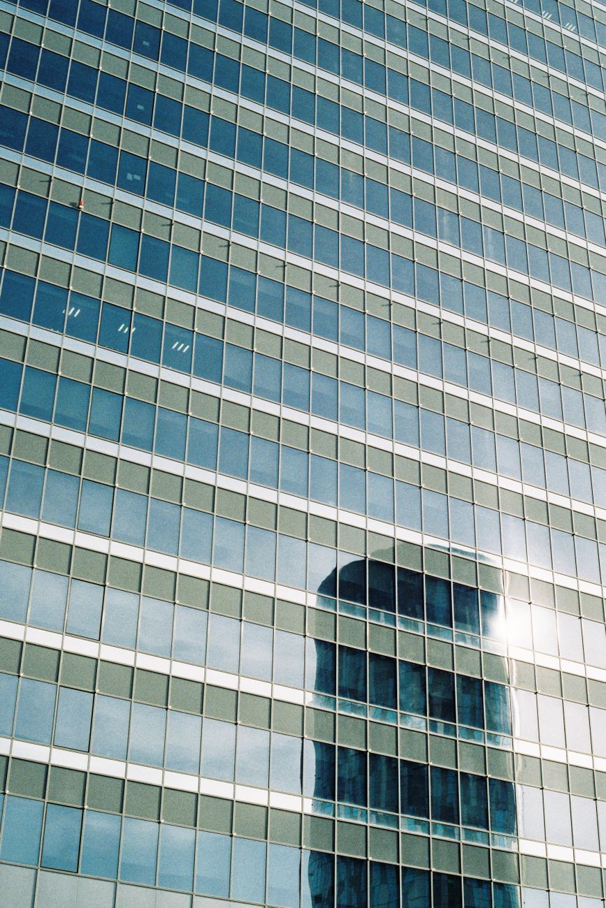 Modern glass skyscraper with reflections in Bucharest, Romania.