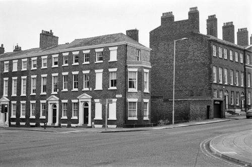 Free Monochrome photo of classic brick buildings on a street corner, capturing architectural style. Stock Photo