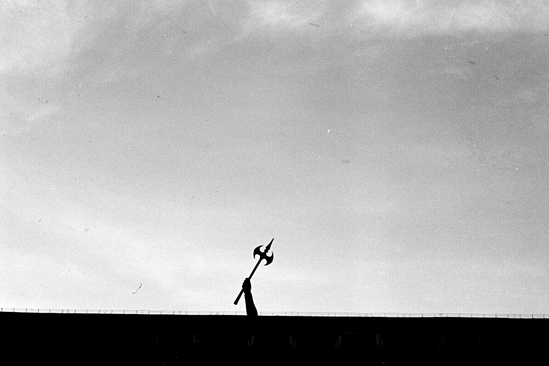 Silhouette of Person Holding A Medieval Battle Axe