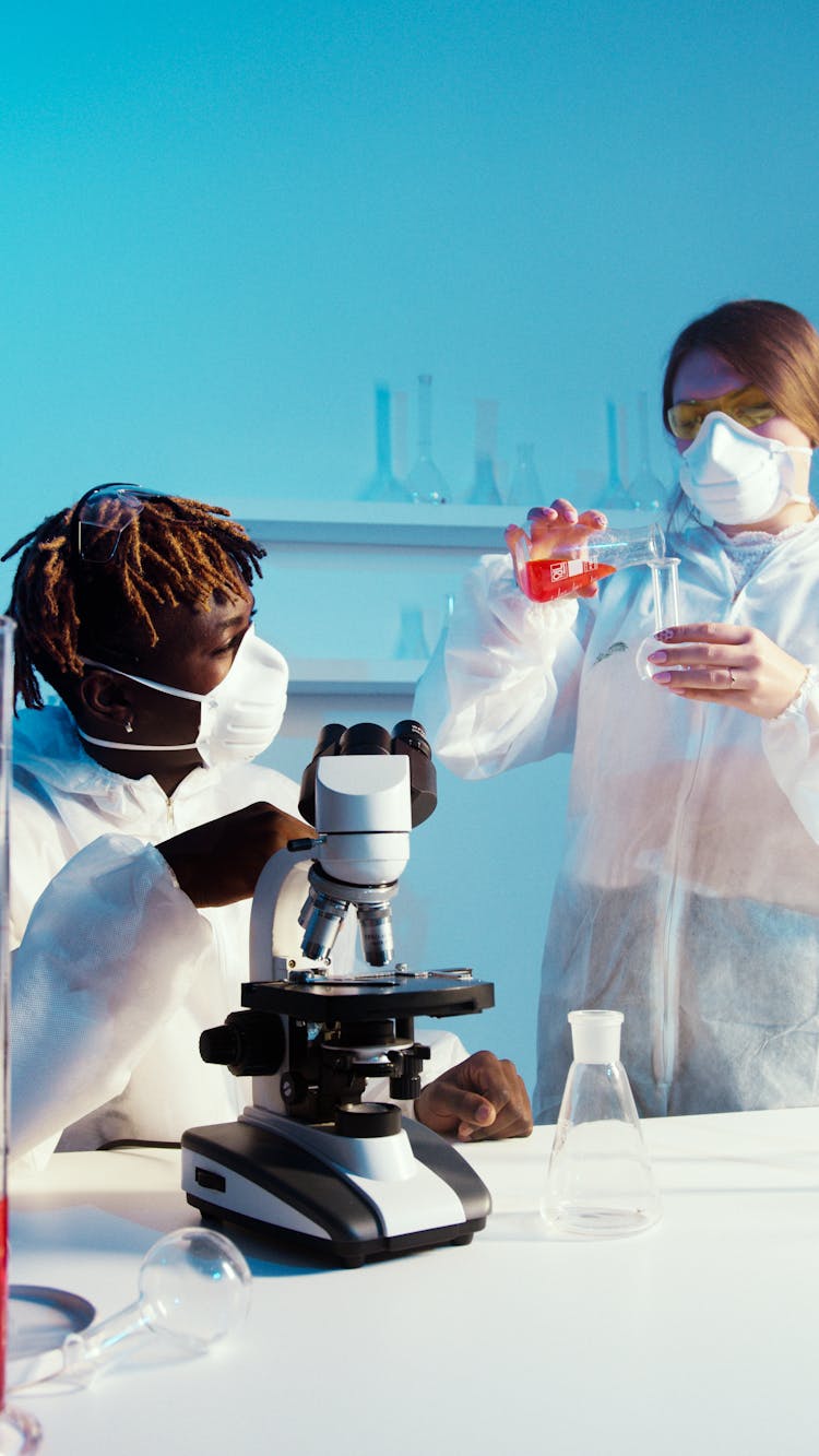 A Man And A Woman Doing An Experiment