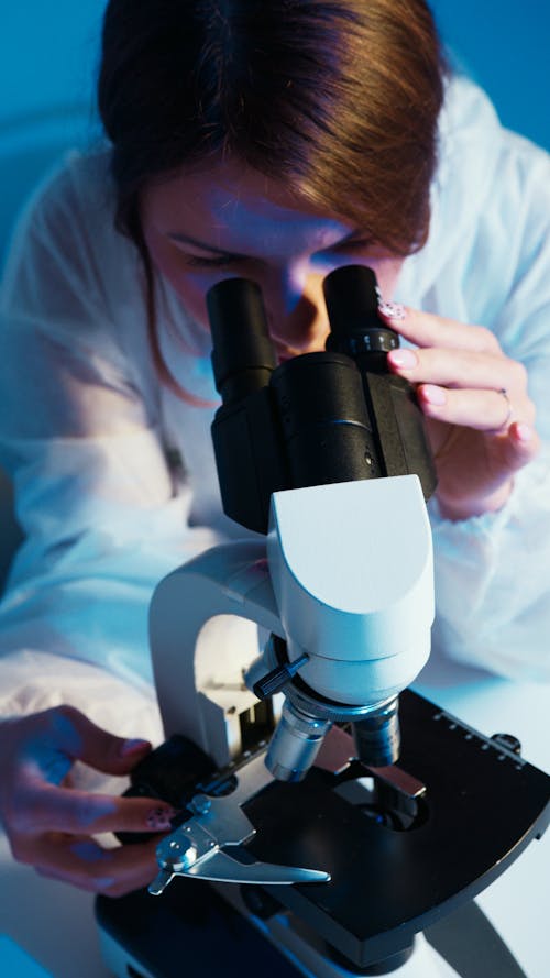 Free A Woman Looking Through the Microscope Stock Photo