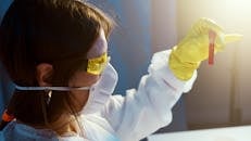 A Woman Holding While Looking at a Blood Tube