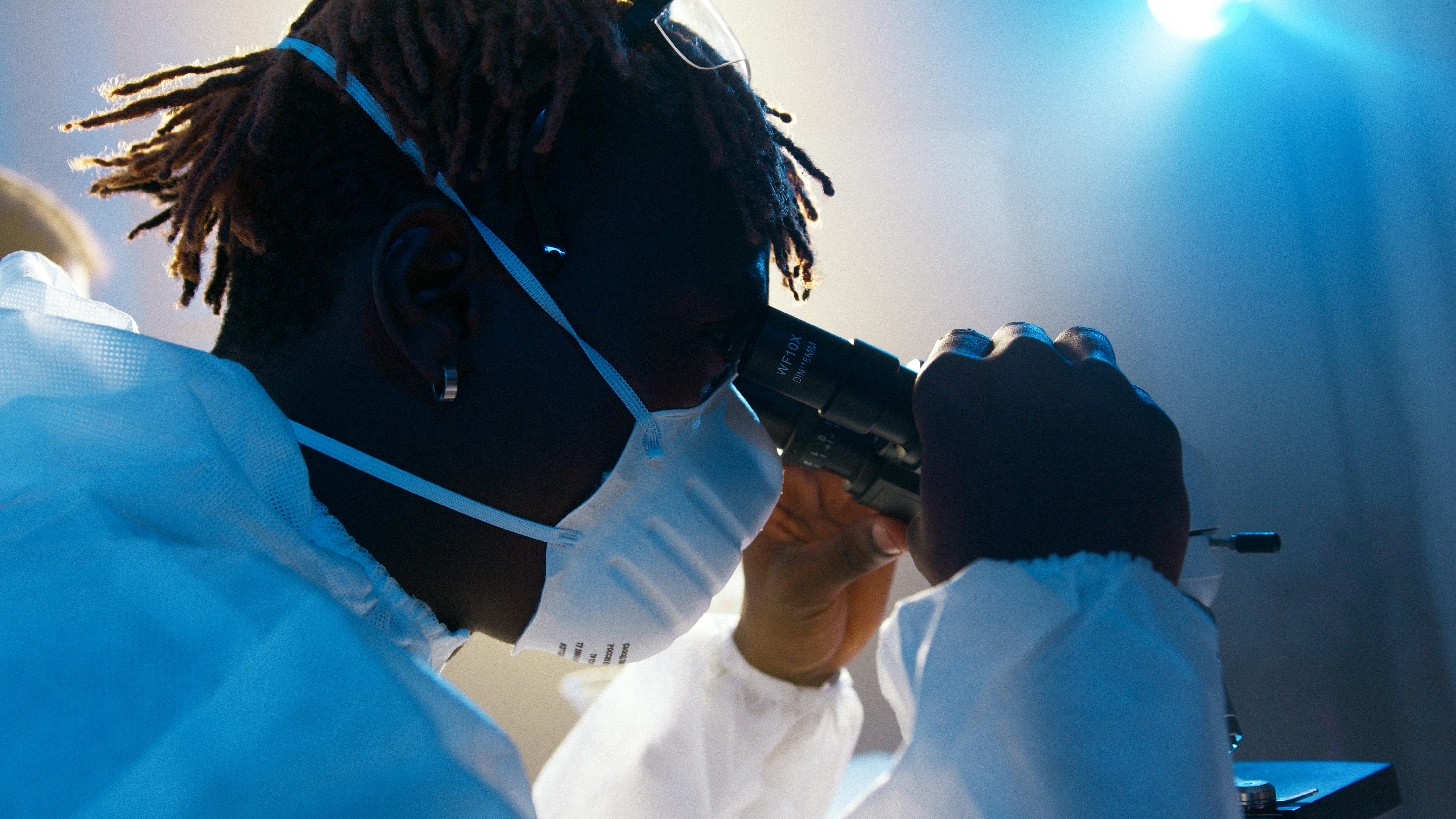 a man looking through the microscope