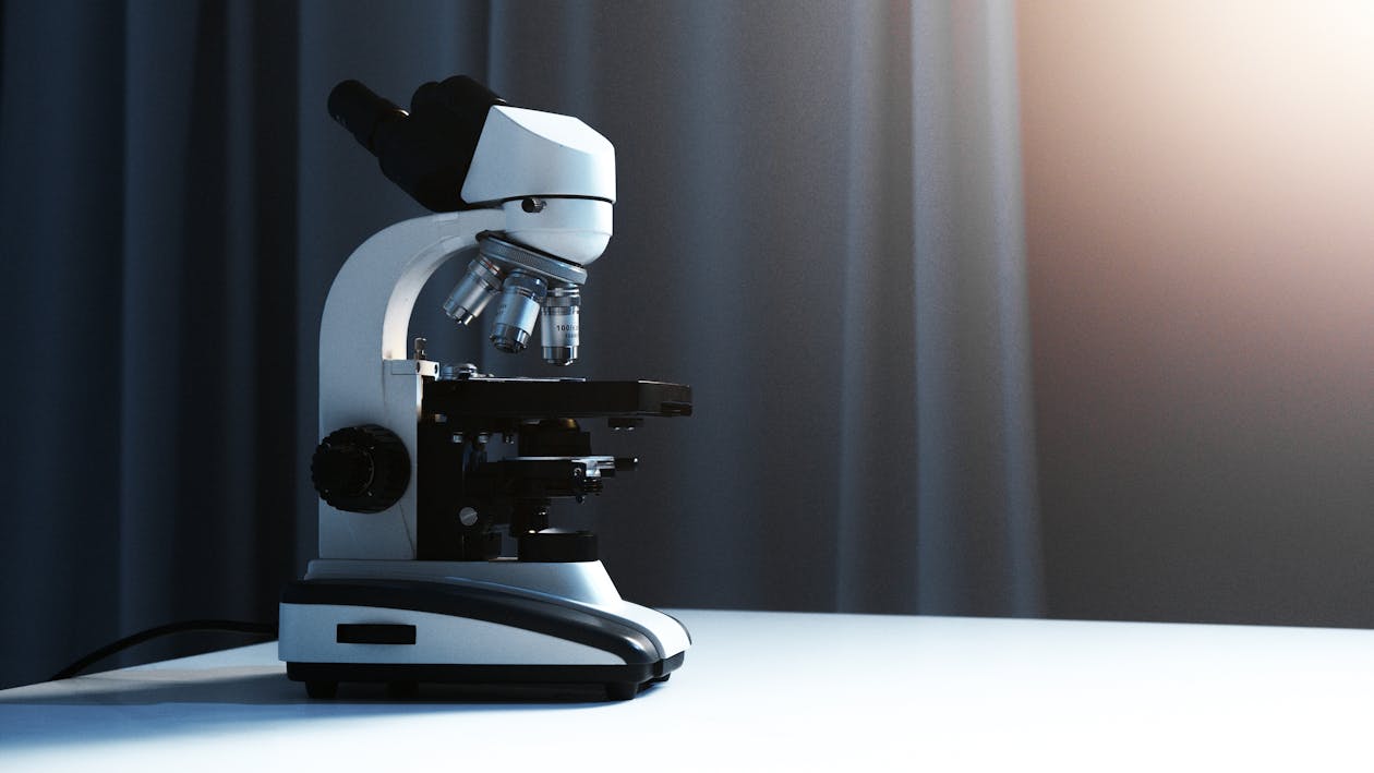 Free A Light Microscope Placed on a White Surface Stock Photo