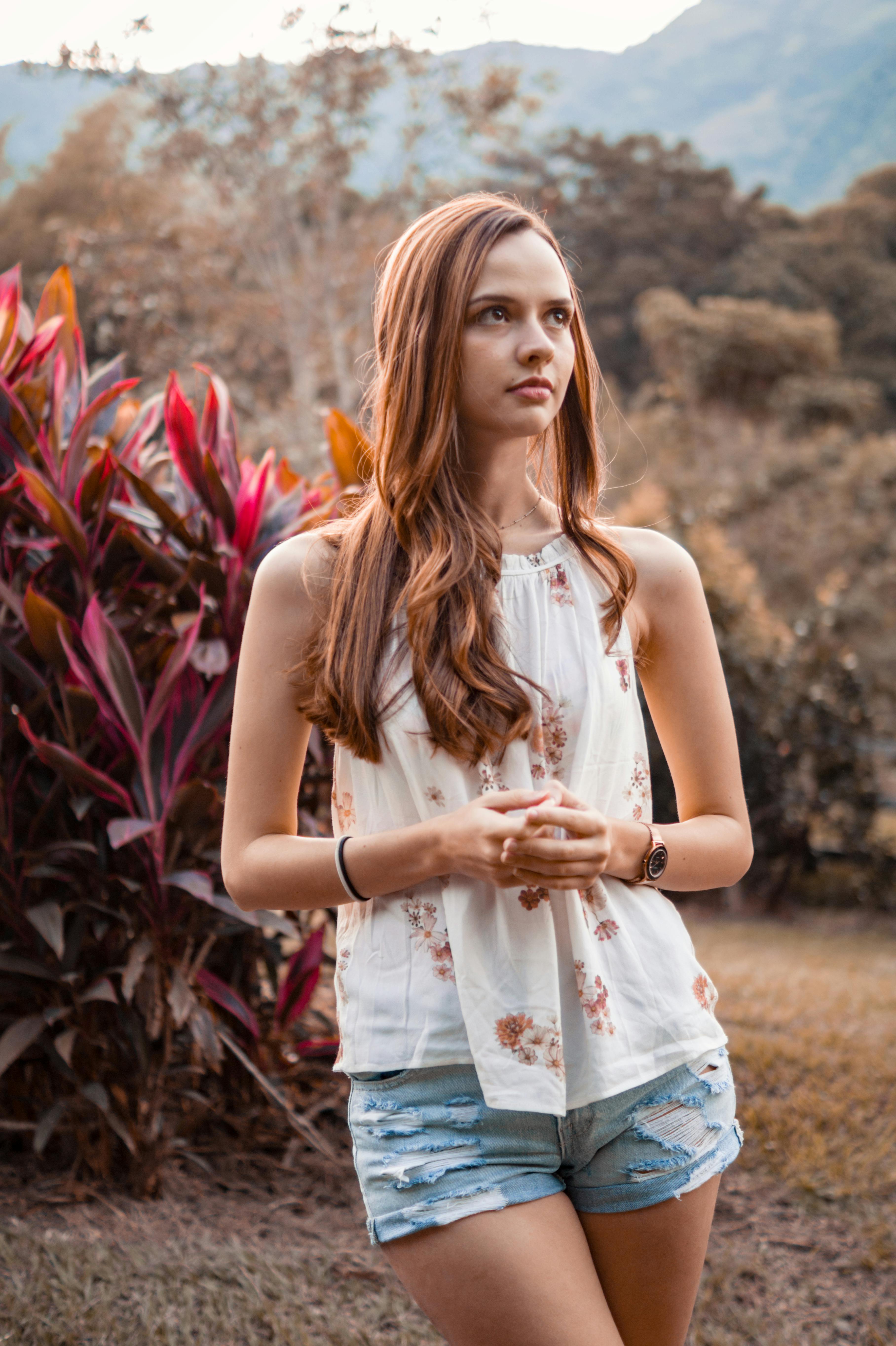 Woman In Sleeveless Shirt And Denim Mini Shorts Stock Photo, Picture and  Royalty Free Image. Image 34179979.