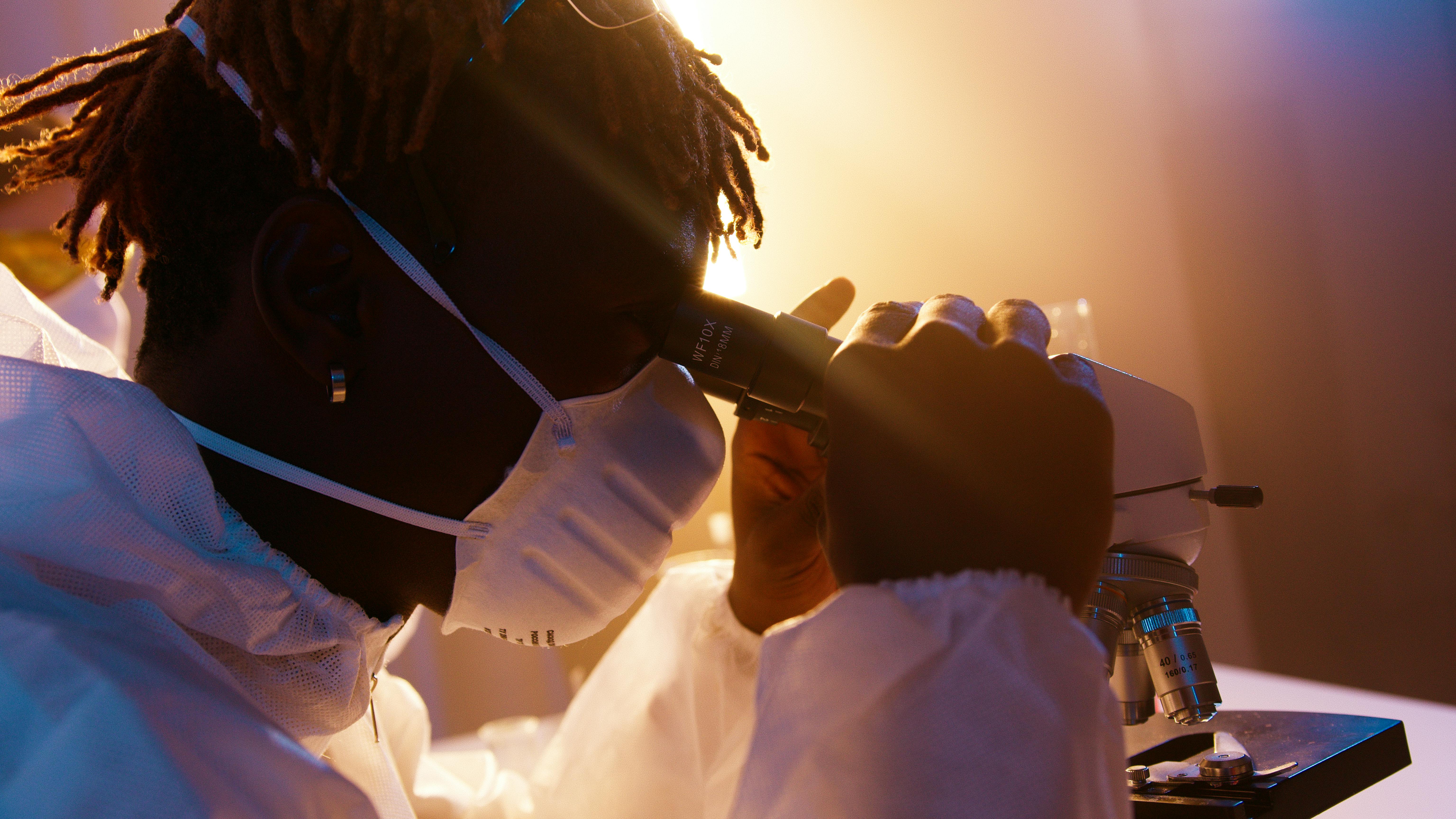 a man looking through the microscope