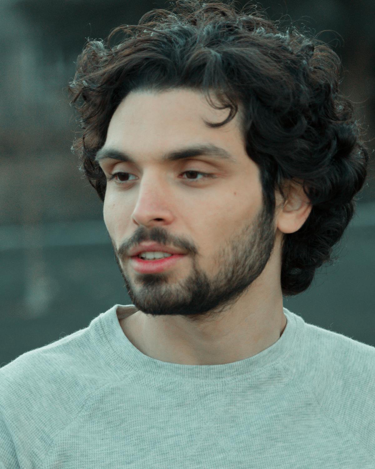 Couple walking along a quiet riverside park path in a city