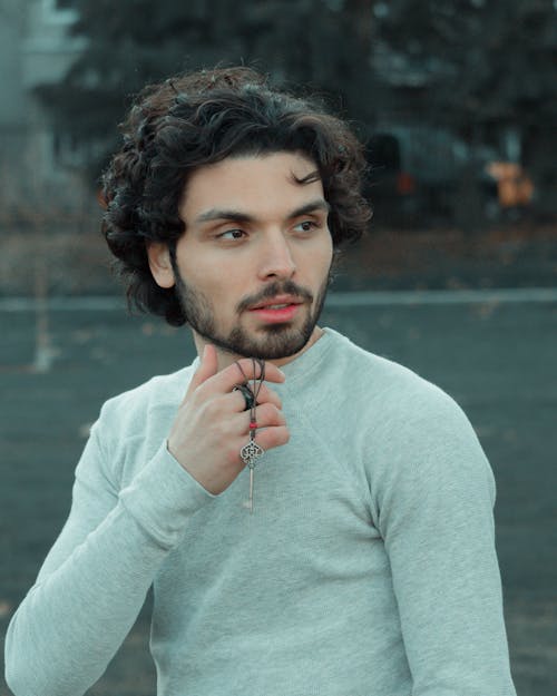 Man in Long Sleeve Shirt With Metal Key On His Hand