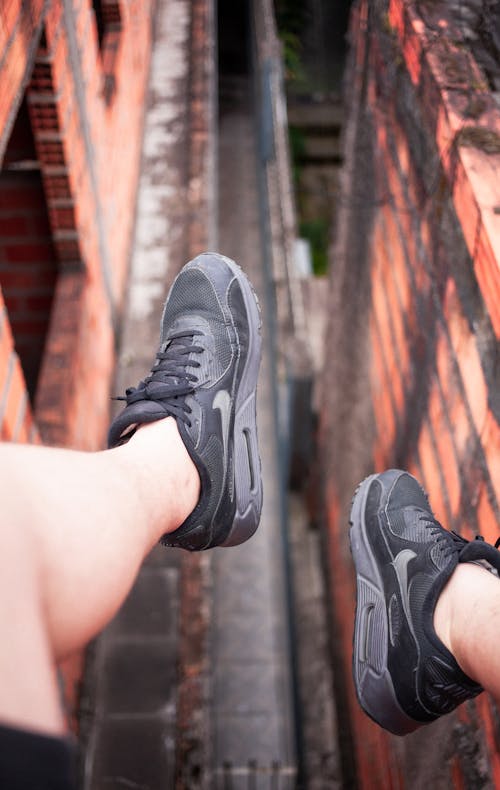 Free Person Wearing Black Nike Running Shoes Stock Photo