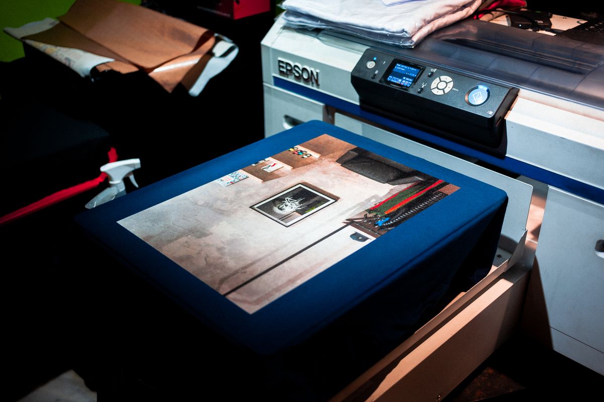 Freshly printed color business materials being finished inside Pressman Print 0813 in Seattle